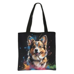 The Watercolor Painting Corgi Shopping Bag showcases a cheerful corgi with brown, white, and black fur on a black bag. Colorful paint splatters in blue, yellow, orange, and green create a vibrant watercolor look.