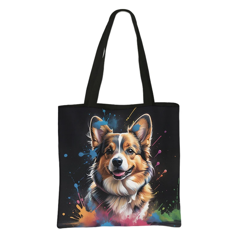 The Watercolor Painting Corgi Shopping Bag showcases a cheerful corgi with brown, white, and black fur on a black bag. Colorful paint splatters in blue, yellow, orange, and green create a vibrant watercolor look.