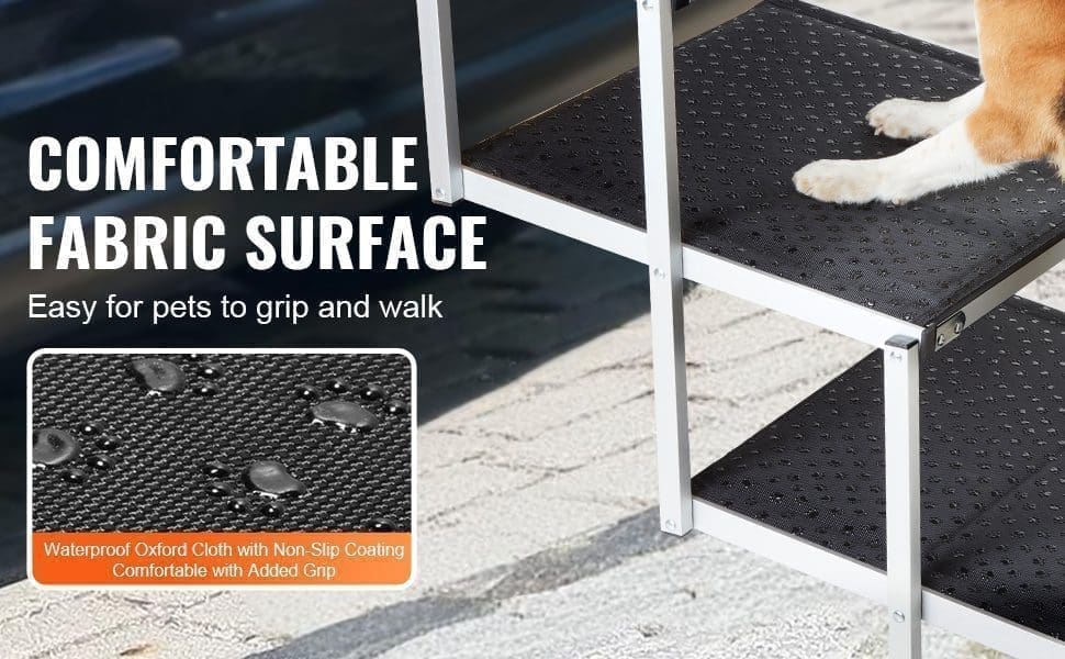 A dog climbs the VEVOR Dog Stair for Cars””a 4-step, lightweight, folding pet step with black, non-slip waterproof oxford fabric treads. Text: “COMFORTABLE FABRIC SURFACE. Easy for pets to grip and walk.” Inset shows a close-up of the fabric.