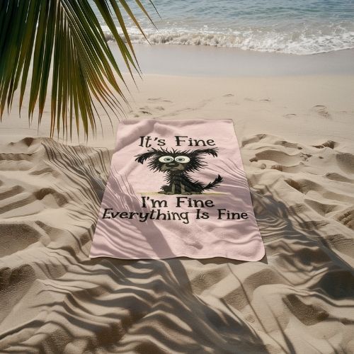 A pink towel on sandy beach near the ocean features a frazzled cartoon creature and the text: Its Fine, Im Fine, Everything Is Fine. Palm leaves hang above, and gentle waves approach in the background.