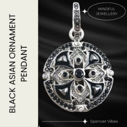 Polished 925 silver pendant with black enamel detailing in a circular design on a black background