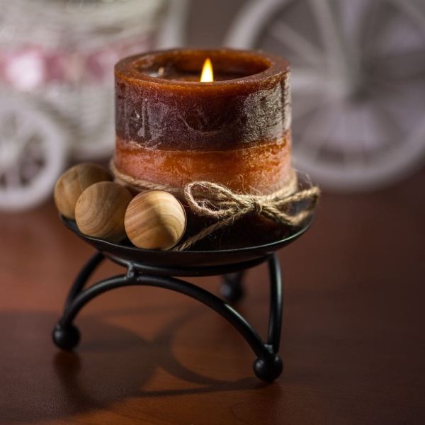 A small brown candle in a candle holder