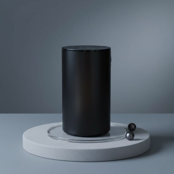 The Essential Oil Diffuser – Waterless Nebuliser USB-C stands upright on a round white platform with a glass ring, flanked by two small black spheres. The background’s smooth grey gradient creates a minimalist, modern display. Includes Free Lavender 10ml & 15% Off Massage Oil.